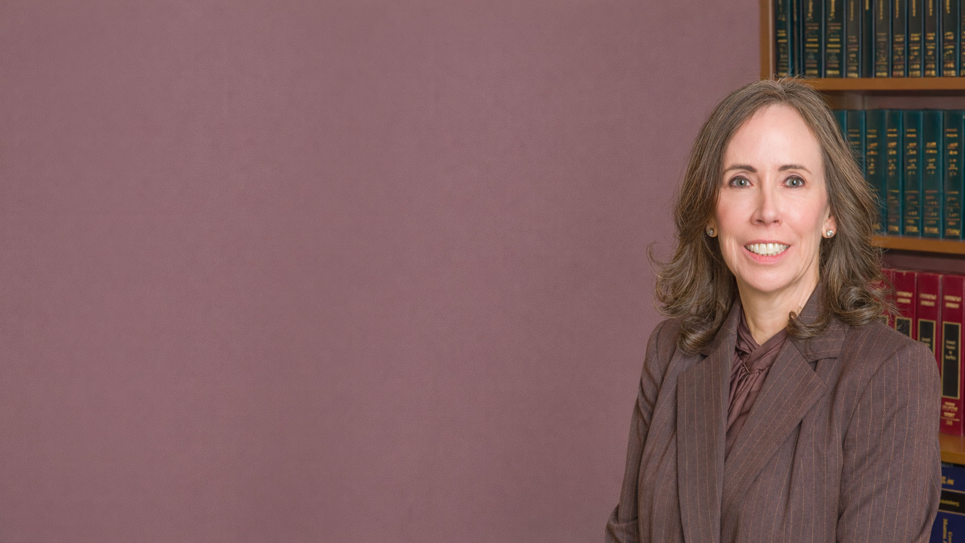 Professional Woman In Front Of Bookshelf
